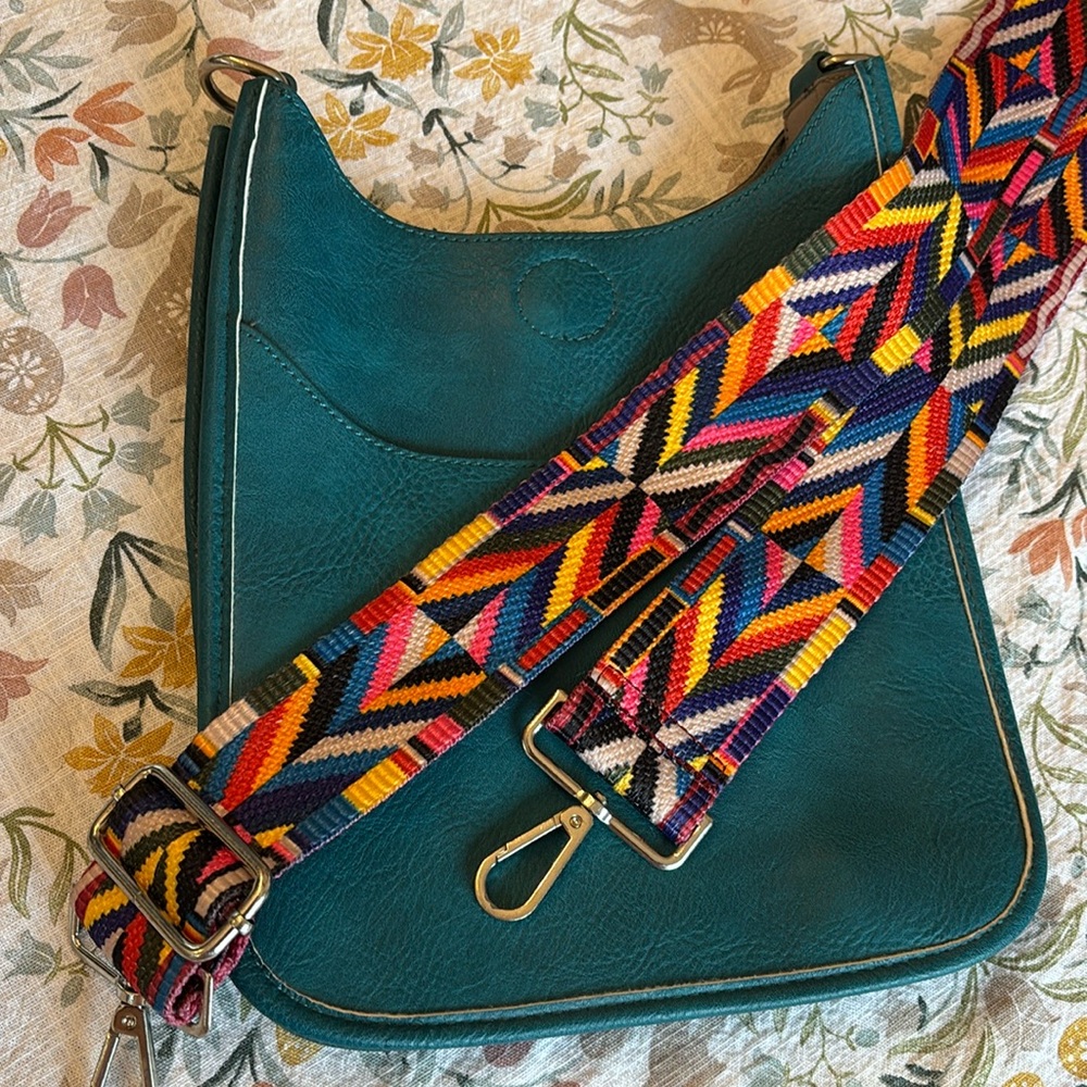 Faux leather teal snap button closure bag with guitar strap